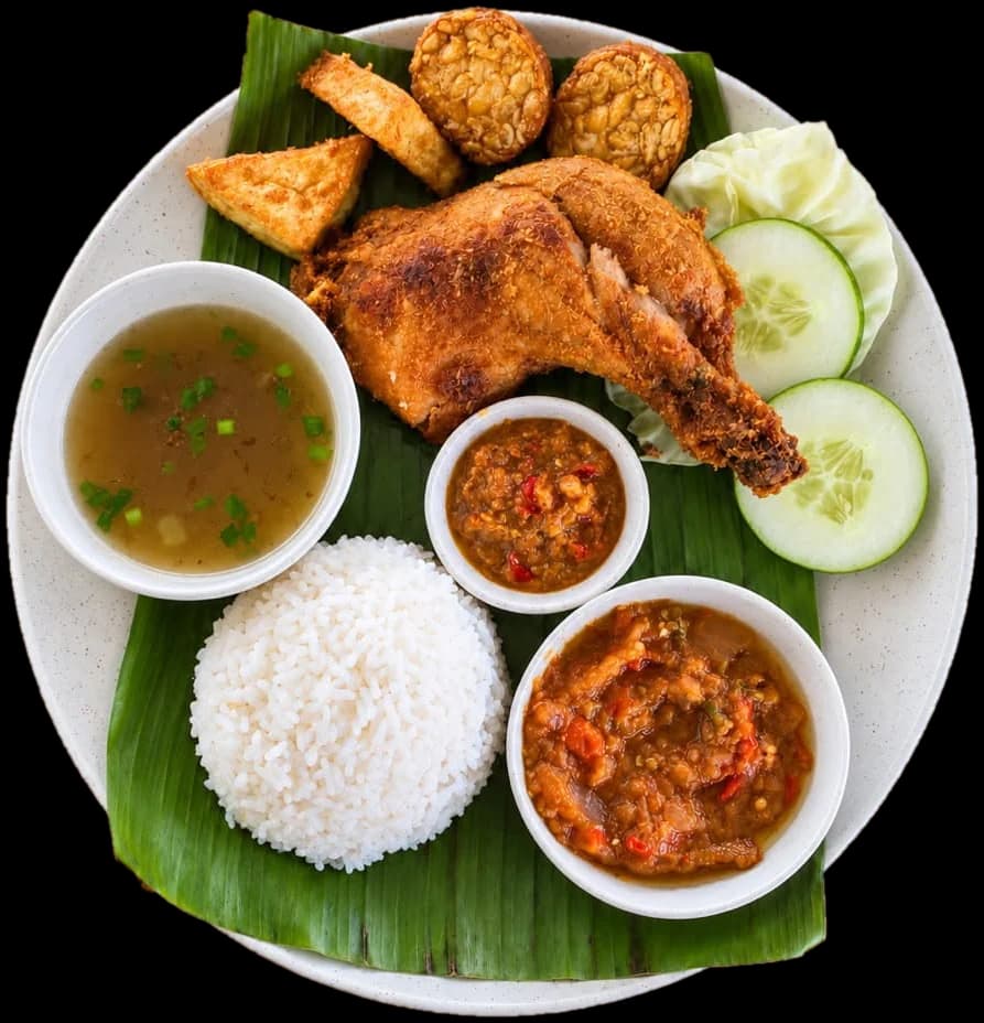 Nasi ayam penyet from D’Cafe: crispy fried chicken on a banana leaf with rice, tempeh, tofu, cucumber, soup and two bowls of sambal