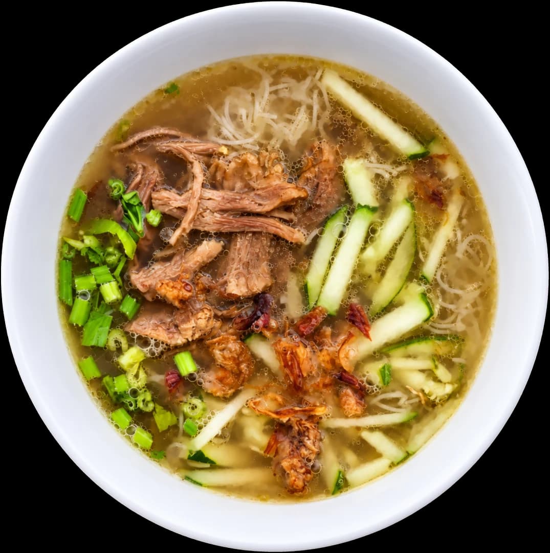 A bowl of soto ayam from D’Cafe: clear chicken soup with bihun, shredded chicken, cucumber, spring onion and crispy shallots