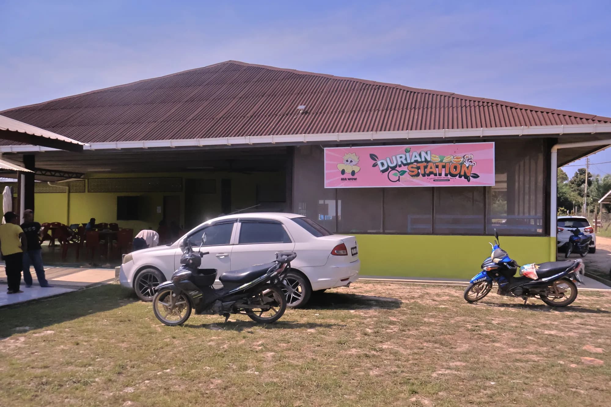 The Durian Station building from the car park, with its pink Durian Station sign